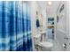 Small bathroom with a standing shower and a stylish blue and white striped shower curtain at 1052 Newton St, Englewood, FL 34224