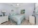 Serene bedroom with wood-look flooring, soft blue accents, and ample natural light at 1052 Newton St, Englewood, FL 34224