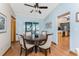 Dining room with wood table, four chairs, and sliding doors to a screened in porch at 1052 Newton St, Englewood, FL 34224