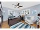 Spacious home office with a large desk, plantation shutters, and a ceiling fan at 1052 Newton St, Englewood, FL 34224