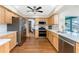 Kitchen featuring stainless appliances, wood cabinets, quartz countertops, and wood-look floors at 1052 Newton St, Englewood, FL 34224