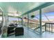 Relaxing covered lanai with stylish outdoor furniture overlooking water views at 1052 Newton St, Englewood, FL 34224