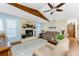 Cozy living room with wood-burning stone fireplace, ceiling fan, and comfortable seating at 1052 Newton St, Englewood, FL 34224