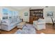 Inviting living room with a sofa, bookshelves, and large windows at 1052 Newton St, Englewood, FL 34224