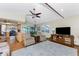Bright living room featuring vaulted ceilings, a ceiling fan, and a seamless flow into the kitchen at 1052 Newton St, Englewood, FL 34224