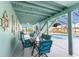 Screened-in patio with a dining table, seating, and views of the pool and outdoor area at 1052 Newton St, Englewood, FL 34224