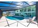 Spacious screened-in pool area with outdoor seating and lush backyard views at 1052 Newton St, Englewood, FL 34224
