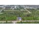 Aerial view of a modern home nestled within lush surroundings, showcasing the desirable neighborhood at 10782 Kearsarge Cir, Port Charlotte, FL 33981