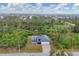 Aerial view of a lovely home nestled in lush surroundings, offering a serene and private setting at 10782 Kearsarge Cir, Port Charlotte, FL 33981