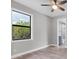 Bedroom with bright window views and an ensuite bath, complete with ceiling fan at 10782 Kearsarge Cir, Port Charlotte, FL 33981