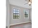 Bright bedroom showcasing two large windows and a ceiling fan at 10782 Kearsarge Cir, Port Charlotte, FL 33981