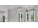 Well-lit dining area with modern light fixture and access to a screened lanai at 10782 Kearsarge Cir, Port Charlotte, FL 33981