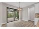 Inviting dining space with stylish chandelier, door to outside, and view of a screened lanai at 10782 Kearsarge Cir, Port Charlotte, FL 33981