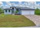 Beautiful home with a brick-paved driveway, three-car garage, manicured lawn, and modern design at 10782 Kearsarge Cir, Port Charlotte, FL 33981