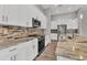 Well-appointed kitchen featuring white cabinetry, granite countertops, and stainless steel appliances at 10782 Kearsarge Cir, Port Charlotte, FL 33981