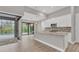 Bright kitchen with white cabinetry, granite countertops, and stainless steel appliances overlooking screened pool at 10782 Kearsarge Cir, Port Charlotte, FL 33981
