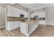 Modern kitchen featuring white cabinets, granite countertops, and stainless steel appliances at 10782 Kearsarge Cir, Port Charlotte, FL 33981