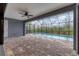 Enclosed lanai featuring beautiful brick pavers, ceiling fan, and view of the sparkling inground pool at 10782 Kearsarge Cir, Port Charlotte, FL 33981