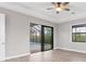 Main bedroom offering access to the screened-in pool via sliding glass doors and a ceiling fan at 10782 Kearsarge Cir, Port Charlotte, FL 33981
