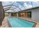 Beautiful pool with brick patio and screened enclosure offering a relaxing outdoor space at 10782 Kearsarge Cir, Port Charlotte, FL 33981