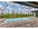 Screened-in pool with brick pavers and a view of the backyard at 10782 Kearsarge Cir, Port Charlotte, FL 33981