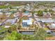 Aerial view of a bright yellow home with a screened-in pool and dock on the water at 1173 Brown St, Englewood, FL 34224