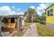 Back yard featuring a storage shed and lush landscaping, with a view of the canal at 1173 Brown St, Englewood, FL 34224