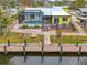 Aerial view of a backyard featuring a screened-in pool, patio, and dock on the water at 1173 Brown St, Englewood, FL 34224