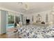 Bright bedroom featuring a queen-sized bed, serene decor, and sliding door access to the screened in pool at 1173 Brown St, Englewood, FL 34224