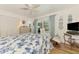 Charming bedroom featuring a queen-sized bed, soft light, and slider leading to screened in pool at 1173 Brown St, Englewood, FL 34224