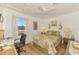 Comfortable bedroom with a desk, floral bedding, and natural light at 1173 Brown St, Englewood, FL 34224