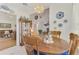Elegant dining area with a wooden table set for four, chandelier, and seamless living room access at 1173 Brown St, Englewood, FL 34224