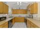 Well-lit kitchen with wood cabinetry, modern appliances, and stylish blue and white accents at 1173 Brown St, Englewood, FL 34224