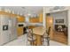 Bright kitchen with stainless steel appliances, marble flooring, and a cozy breakfast bar at 1173 Brown St, Englewood, FL 34224
