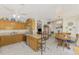 Open-concept kitchen with breakfast bar that flows into a dining area, bathed in natural light and decorated with blue accents at 1173 Brown St, Englewood, FL 34224