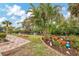 View of the lush landscaping with many potted plants next to the canal at 1173 Brown St, Englewood, FL 34224