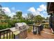 Outdoor stainless steel gas grill on a wood deck, overlooking the canal and lush landscaping at 1173 Brown St, Englewood, FL 34224