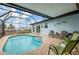Enclosed backyard pool with a seating area and sunny exposure at 1173 Brown St, Englewood, FL 34224