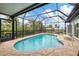 Beautiful enclosed pool with patio and peaceful green backyard view at 1173 Brown St, Englewood, FL 34224