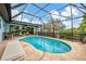 Enclosed pool area with lounge chairs and a scenic view of the water at 1173 Brown St, Englewood, FL 34224