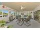 Inviting sunroom with a dining table and walls of windows, full of decorations at 1173 Brown St, Englewood, FL 34224