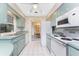 Functional kitchen with vintage appliances and a view into the dining room at 12 Charleston Cir, Englewood, FL 34223