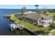 The aerial view showcases the waterfront location, well maintained lawn and landscaping, and outdoor living spaces at 12432 Nova Ave, Port Charlotte, FL 33981