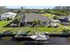 A beautiful home featuring a private dock and backyard with direct water access and a well maintained lawn at 12432 Nova Ave, Port Charlotte, FL 33981