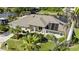 An elevated view shows this homes prime waterfront location, lush greenery, and solar paneling at 12432 Nova Ave, Port Charlotte, FL 33981