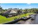 Waterfront home featuring a screened lanai, private dock with boat lift, and lush tropical landscaping at 12432 Nova Ave, Port Charlotte, FL 33981