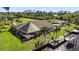 Aerial view of waterfront house showing screened lanai, boat dock with lift, and lush landscaping at 12432 Nova Ave, Port Charlotte, FL 33981
