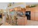 Well-appointed kitchen with granite countertops, custom cabinetry, stainless appliances, and breakfast bar seating at 12432 Nova Ave, Port Charlotte, FL 33981