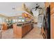 Expansive kitchen island with granite counters, seating, and prep sink overlooking the living area and lake at 12432 Nova Ave, Port Charlotte, FL 33981