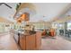 Open kitchen design flows into living area with island sink, granite countertops, and views of the lake at 12432 Nova Ave, Port Charlotte, FL 33981